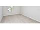 Bright, carpeted bedroom featuring a window letting in natural light at 1411 Hamilton Way, Lake Alfred, FL 33850