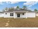 The backyard has a covered patio and white exterior at 14404 Sw 19Th Pl, Ocala, FL 34481
