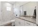 Bright bathroom featuring a modern vanity and a walk-in shower with marble tile at 14404 Sw 19Th Pl, Ocala, FL 34481