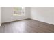 Large bedroom with wood-look floors and a view of the front yard at 14404 Sw 19Th Pl, Ocala, FL 34481