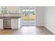 Bright kitchen features stainless steel appliances, white cabinetry, granite countertops, and sliding door access at 14404 Sw 19Th Pl, Ocala, FL 34481