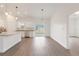 Bright, open kitchen featuring stainless steel appliances, granite counters, and wood-style flooring at 14404 Sw 19Th Pl, Ocala, FL 34481