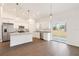 Bright kitchen boasts stainless steel appliances, granite countertops, a center island, and sliding door access at 14404 Sw 19Th Pl, Ocala, FL 34481