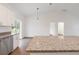 Kitchen featuring granite countertops, stainless steel appliances, white cabinetry, and hardwood flooring at 14404 Sw 19Th Pl, Ocala, FL 34481