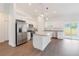 Bright kitchen boasts stainless steel appliances, granite countertops, a center island, and sliding door access at 14404 Sw 19Th Pl, Ocala, FL 34481