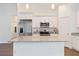 Kitchen featuring granite countertops, stainless steel appliances, white cabinetry, and hardwood flooring at 14404 Sw 19Th Pl, Ocala, FL 34481
