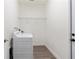 Bright laundry room featuring a white washer and wire shelving at 14404 Sw 19Th Pl, Ocala, FL 34481
