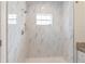 Elegant shower with marble tile walls and a built-in shower niche at 14404 Sw 19Th Pl, Ocala, FL 34481