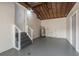 Unfinished basement space ready for customization with concrete walls, visible ceiling beams, and exterior access at 406 W Valencia St, Lakeland, FL 33805
