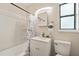 Bathroom featuring a shower-tub combo, modern vanity, contemporary fixtures, and a bright, clean aesthetic at 406 W Valencia St, Lakeland, FL 33805