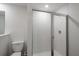 Clean bathroom featuring a toilet and a glass-enclosed shower stall with white tile at 587 Bay Leaf Dr, Poinciana, FL 34759