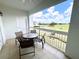 Charming balcony with outdoor seating and a scenic view of the golf course at 7673 Heritage Crossing Way # 202, Reunion, FL 34747