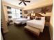 Bright bedroom featuring two beds, decorative animal accents, and a ceiling fan at 7673 Heritage Crossing Way # 202, Reunion, FL 34747