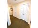 Neutral-toned hallway with multiple doors and a patterned carpet at 7673 Heritage Crossing Way # 202, Reunion, FL 34747