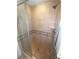 Bathroom features tile walls with an adjustable shower head and glass door at 7673 Heritage Crossing Way # 202, Reunion, FL 34747