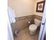 Cozy toilet room with decorative wall tiles, towel rack, and framed wall art at 7673 Heritage Crossing Way # 202, Reunion, FL 34747