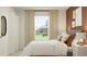 Bright bedroom featuring a large window, neutral-toned walls, and comfortable bedding at 990 Hour Glass Rd, Lakeland, FL 33801