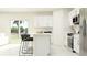 Bright, modern kitchen with white cabinetry, stainless steel appliances, and a sleek breakfast bar at 990 Hour Glass Rd, Lakeland, FL 33801