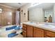 Well-lit bathroom features a double vanity, tiled shower, and coordinated fixtures at 2138 Mirasol Dr, Winter Haven, FL 33881