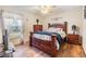 Comfortable bedroom with hardwood floors, a statement headboard, and natural light at 2138 Mirasol Dr, Winter Haven, FL 33881