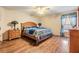 Comfortable bedroom featuring hardwood floors, ceiling fan, and matching wood furniture at 2138 Mirasol Dr, Winter Haven, FL 33881