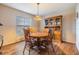 Cozy dining room with wooden table, chairs, hutch, chandelier, and window views at 2138 Mirasol Dr, Winter Haven, FL 33881