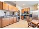 Bright kitchen featuring stainless steel appliances, wood cabinets, granite countertops, and tiled floor at 2138 Mirasol Dr, Winter Haven, FL 33881