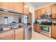 Well-lit kitchen featuring stainless steel appliances, granite countertops, and wood cabinets at 2138 Mirasol Dr, Winter Haven, FL 33881