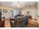Bright living room with ceiling fan, sliding glass door, wood flooring, and comfortable seating at 2138 Mirasol Dr, Winter Haven, FL 33881