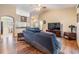 Spacious living room featuring wood floors, comfortable seating, TV, and natural light at 2138 Mirasol Dr, Winter Haven, FL 33881