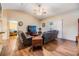 Well-lit living room with ceiling fan, wood flooring, comfortable couches, and TV setup at 2138 Mirasol Dr, Winter Haven, FL 33881