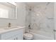 Bright bathroom features a white vanity with quartz counters and a shower with marbled tile surround at 2686 Sw 144Th Ct, Ocala, FL 34481