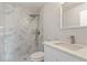 Updated bathroom features white marble tile, a waterfall shower head, and a white vanity at 2746 Sw 147Th Ct, Ocala, FL 34481