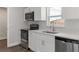 Modern kitchen showcasing stainless steel appliances and stylish white cabinetry at 2746 Sw 147Th Ct, Ocala, FL 34481