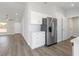 Bright kitchen featuring white cabinets, stainless steel appliances, and wood-look flooring at 2746 Sw 147Th Ct, Ocala, FL 34481