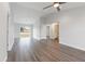 Open concept living room with wood-look floors, ceiling fan, and sliding glass doors to the outside at 2746 Sw 147Th Ct, Ocala, FL 34481
