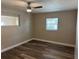 Comfortable bedroom with wood-look flooring, neutral paint, and bright natural light at 400 Sw 1St Ave, Mulberry, FL 33860