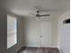 Cozy bedroom featuring natural light, wood-look flooring, and modern ceiling fan at 400 Sw 1St Ave, Mulberry, FL 33860