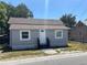 Charming single-story home with a gray exterior, white trim, and a well-maintained front yard at 400 Sw 1St Ave, Mulberry, FL 33860