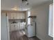 Well-lit kitchen with white appliances and cabinets, backsplash and modern flooring at 400 Sw 1St Ave, Mulberry, FL 33860