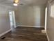 Inviting living room with wood-look flooring and a ceiling fan for added comfort at 400 Sw 1St Ave, Mulberry, FL 33860