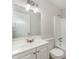 Well-lit bathroom features a large mirror and a shower/tub combination with white tiling at 1313 Periwinkle Ct, Lakeland, FL 33811
