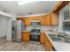 Well-lit kitchen featuring stainless steel appliances and modern wood cabinets at 1313 Periwinkle Ct, Lakeland, FL 33811