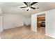 Spacious living area with modern light-colored wood floors and contemporary ceiling fan at 1313 Periwinkle Ct, Lakeland, FL 33811