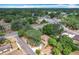 Aerial shot of a charming home nestled amongst mature trees in a quiet neighborhood at 713 W 3Rd St, Lakeland, FL 33805