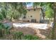 View of the back of the house with a large concrete pad and storage shed at 713 W 3Rd St, Lakeland, FL 33805