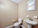 Powder room featuring a modern sink and toilet with a neutral paint scheme at 713 W 3Rd St, Lakeland, FL 33805