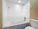 Clean bathroom with a large bathtub and shower features tiled walls and a showerhead at 713 W 3Rd St, Lakeland, FL 33805