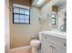Bright bathroom featuring a modern vanity, toilet and a window at 713 W 3Rd St, Lakeland, FL 33805