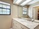 Bathroom features a double sink vanity with a large mirror and bright natural light at 713 W 3Rd St, Lakeland, FL 33805